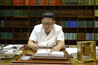 A picture released from North Korea’s official Korean Central News Agency on Saturday shows President Kim Jong-un of North Korea signing documents for a test launch of an intercontinental ballistic missile. Credit Agence France-Presse — Getty Images